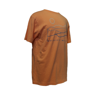 Angled view of coral Wachusett Mountain t-shirt showing blue mountain line-art and sun design across the back, highlighting soft cotton fabric and relaxed fit