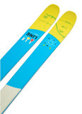 Close-up of LINE Tom Wallisch Pro ski tails: blue and yellow twin-tip design with playful atomic and measurement graphics for freestyle performance