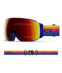Smith I/O MAG Justin Lovato Red Snow Goggles with ChromaPop Sun Red Mirror lens: artistic red, yellow, and blue gradient strap for bold mountain style. Offers quick MAG lens interchange, anti-fog tech, and superior peripheral vision