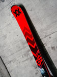 Tip of Volkl Racetiger GS R single ski leaning against a concrete wall