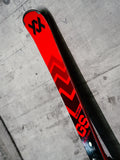 Tip of Volkl Racetiger GS R single ski leaning against a concrete wall