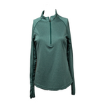 Front view of women’s emerald green long-sleeve quarter-zip pullover with athletic fit and collar